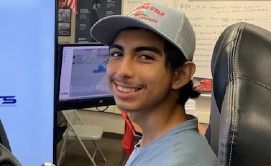 High school senior Eduardo Dominguez-Sotelo sits behind the wheel of a simulator of an 18-wheeler, a part of the Patterson High School truck driving program.