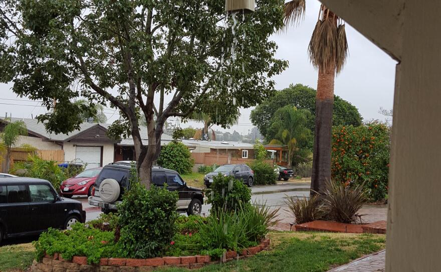 Rain falling from a gutter at a home in the El Cerrito neighborhood of San Diego, Jan. 5, 2016.