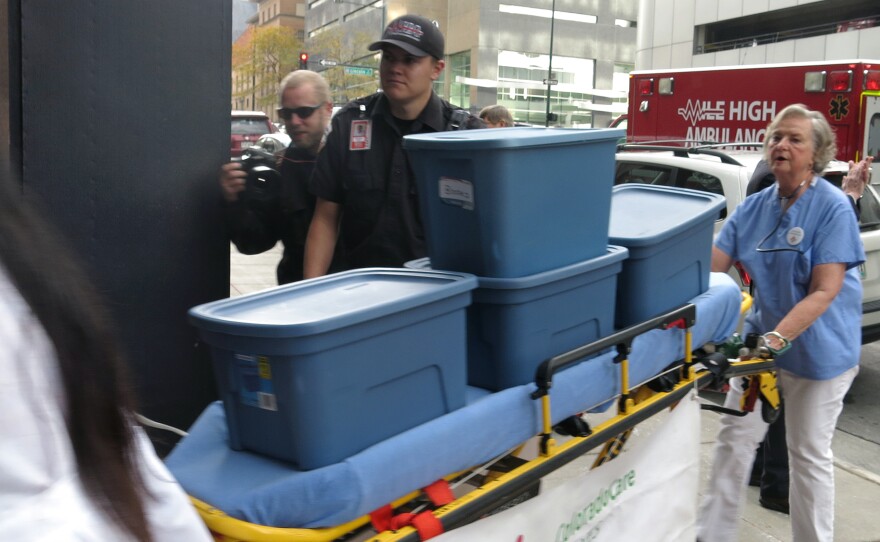 Supporters of single-payer health care delivered signatures supporting their ballot measure on a stretcher to Colorado's secretary of state.