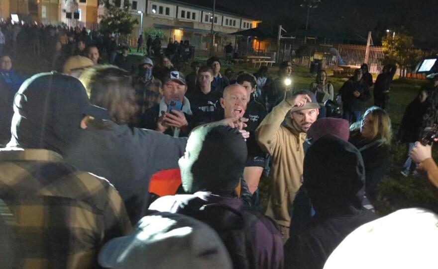 A crowd of anti-trans activists, including members of the Proud Boys and other extremists, confronts anti-fascists outside the Santee YMCA on the night of Jan. 18, 2023, and Navy SEAL Bryce Henson stands among the extremists.