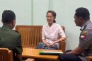 In this undated photo provided on April 30, 2026, by the Myanmar Military True News Information Team, the country's former leader Aung San Suu Kyi, center, talks with officials in an undisclosed location in Myanmar.