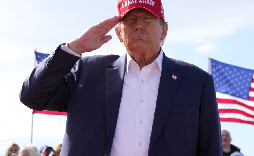 Former President Donald Trump, the Republican presidential candidate, salutes at a campaign rally on March 16 in Vandalia, Ohio.
