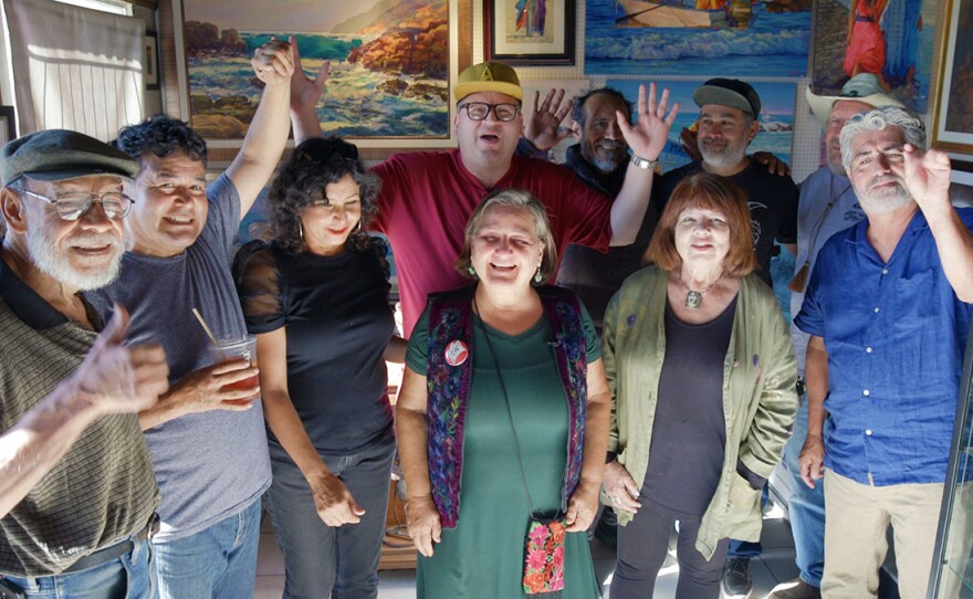 Host Jorge Meraz takes a group photo with many famous artists at the Polos Art Gallery in Rosarito, Mexico.