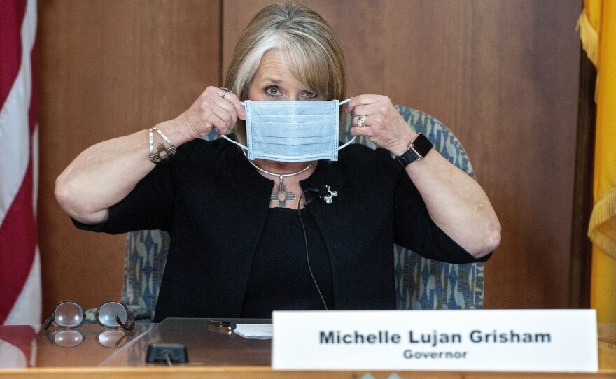 Lujan Grisham puts on her face mask when not speaking during an April 15 update on the COVID-19 outbreak in the state.