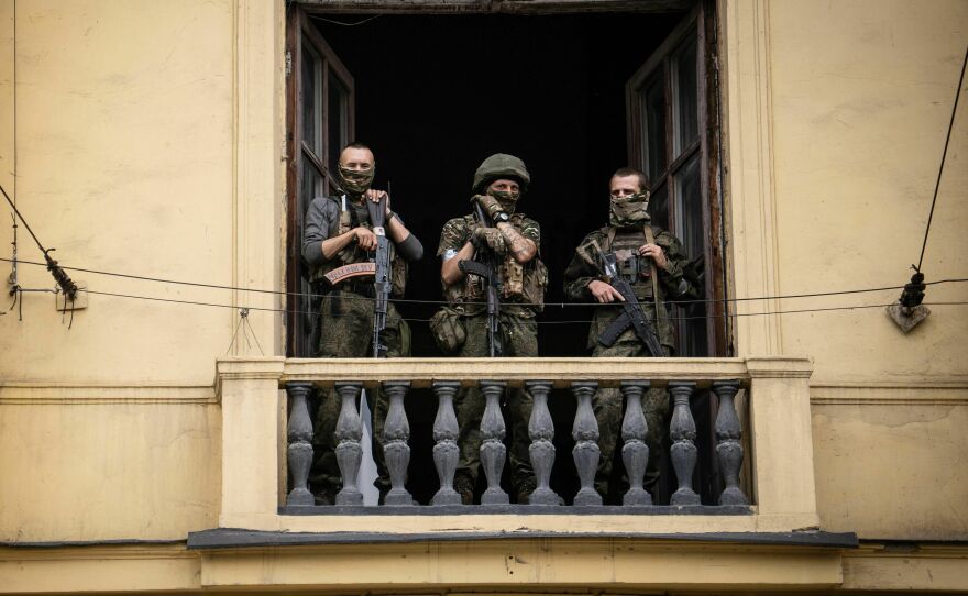Members of Wagner Group stand on the balcony of a building in the city of Rostov-on-Don on Saturday.