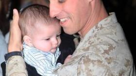 Lance Cpl. Gorge Rodriguez holds his son William for the first time.