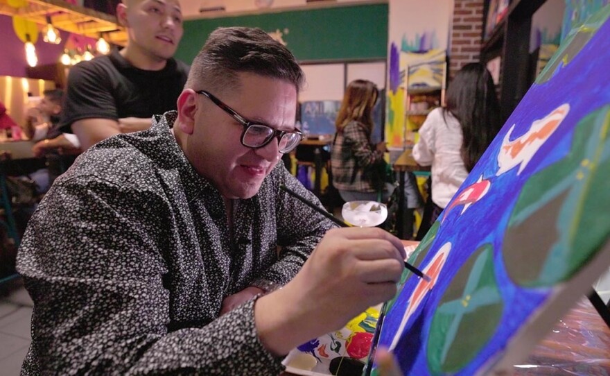 Host Jorge Meraz tries out his painting skills at the Unika Paitning Bar in Tijuana, Mexico.