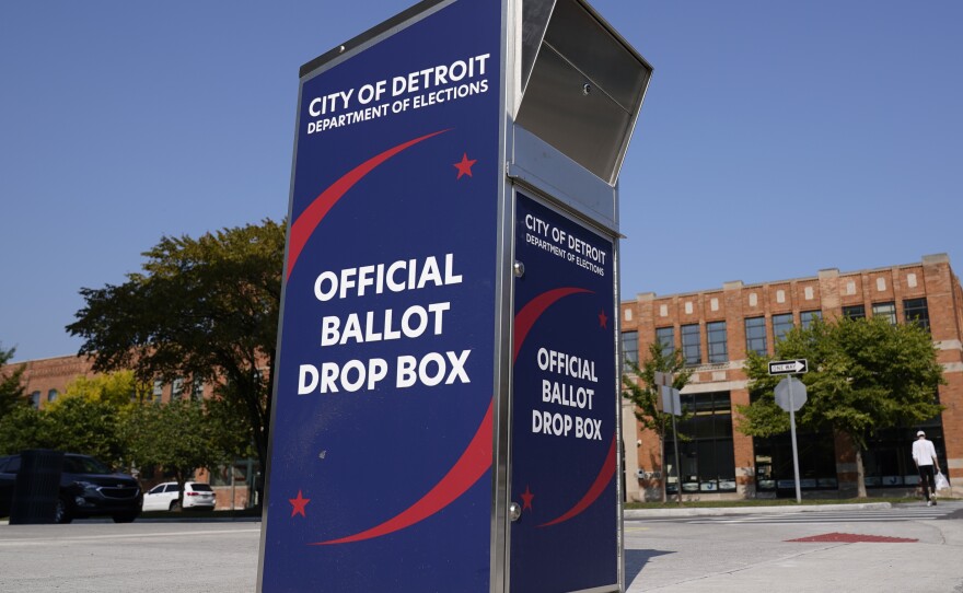 Voters can drop off absentee ballots at a ballot drop box in Detroit instead of using the mail.
