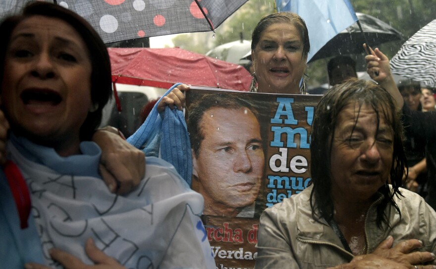 Under heavy rain, people take part in a "Marcha del silencio" (March of Silence) Wednesday in Buenos Aires, Argentina, one month after the death of prosecutor Alberto Nisman.