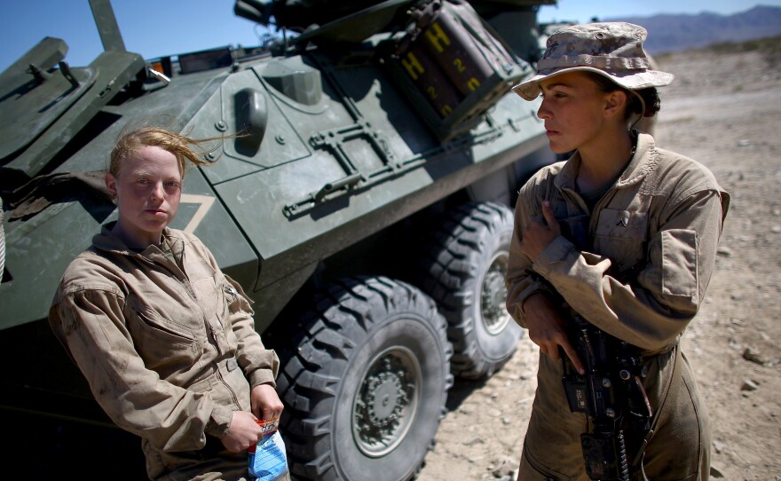 Lance Cpl. Brittany Holloway (left) talks with Brittany Dunklee in front of their LAV-25 vehicle.