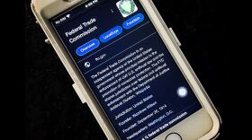 A cell phone displays information on the FTC in this undated photo.