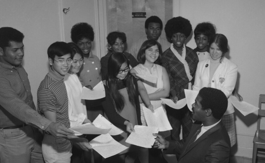 Students present essays to Dr. Ernest Hartzog, the first African-American principal in San Diego. 