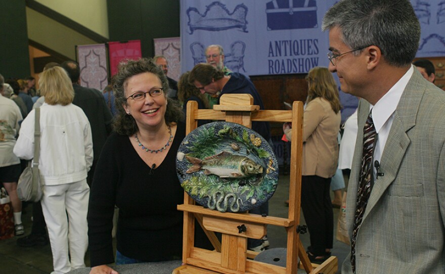 Stuart Slavid (right) appraises a Palissyware fish platter, ca. 1900 in San Francisco, Calif. 