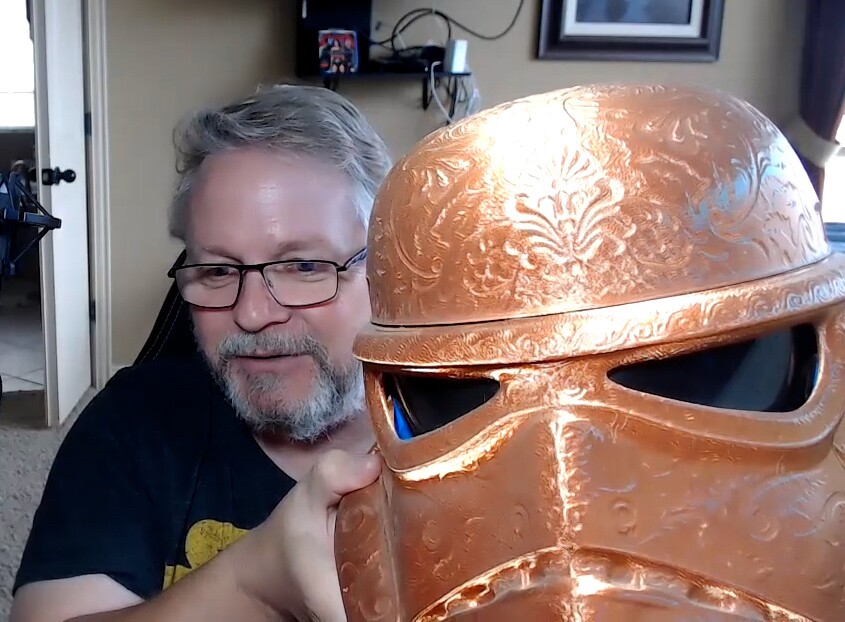 "Star Wars" fan Mark Tuttle shows off a gold Stormtrooper helmet he made.
