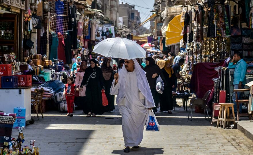 An Egyptian man walks down the street at the Khan al-Khalili market in Cairo.