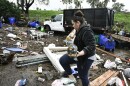 Marlene Sanchez-Barriento salavages items behind her home damaged by flooding, Tuesday, Jan. 23, 2024, in. Sanchez-Barriento's home was damaged when flood waters rushed though her home on Monday, Jan. 22.