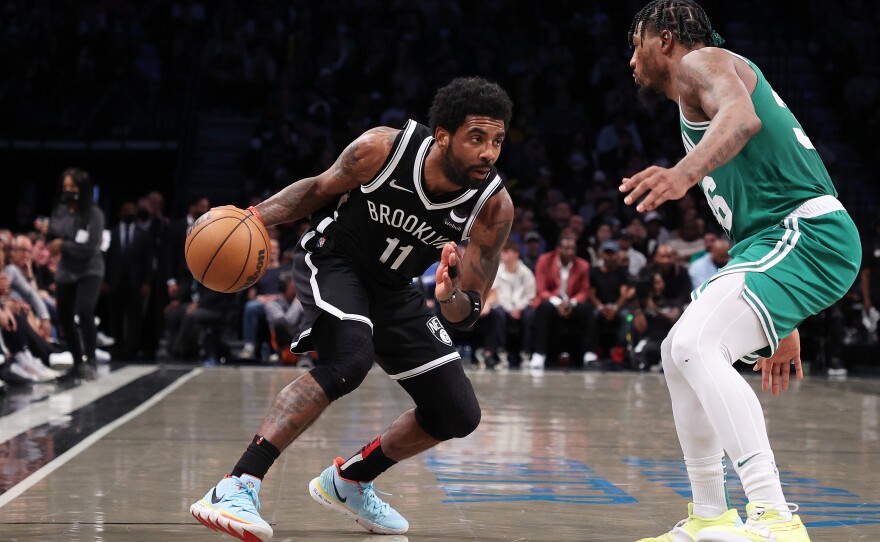 Kyrie Irving of the Brooklyn Nets drives against Marcus Smart of the Boston Celtics during Game 3 of the Eastern Conference first round in the 2022 NBA playoffs at Barclays Center.