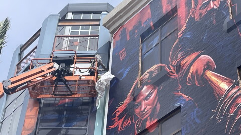 Crews taking down the building wraps in downtown San Diego after Comic-Con ended, July 27, 2026.