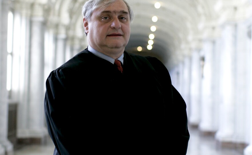 Alex Kozinski, then-chief judge on the U.S. 9th Circuit Court of Appeals, stand inside the James L. Browning Courthouse in San Francisco in 2009.