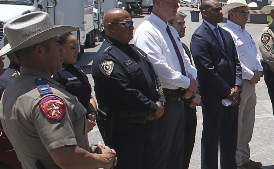 Uvalde School Police Chief Pete Arredondo, third from left, stands during a news conference outside of the Robb Elementary school in Uvalde, Texas Thursday, May 26, 2022.