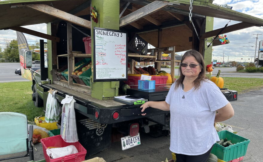 Sabrina Haney, 54, stands next to Skonieczny's vegetable cart in Caribou, Maine.