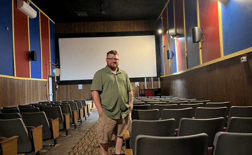 Brandon Goding, 43, stands in the center aisle of one of his two movie auditoriums at Fort Kent Theater.