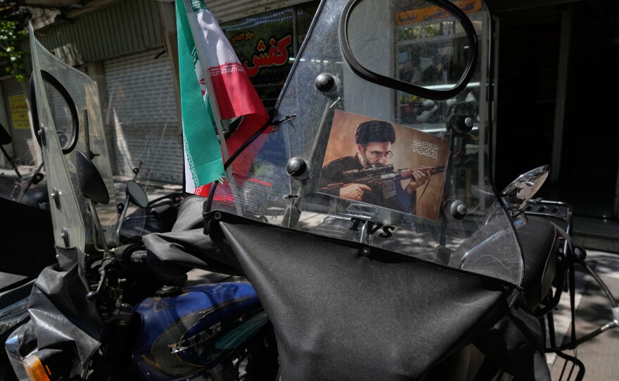 A poster is pasted on a motorbike windshield with graphic depicting Iran's Supreme Leader Ayatollah Mojtaba Khamenei as government supporters gather to mark the 40th day since the killing of his father, Supreme Leader Ayatollah Ali Khamenei, in Tehran, Iran, Thursday, April 9, 2026.