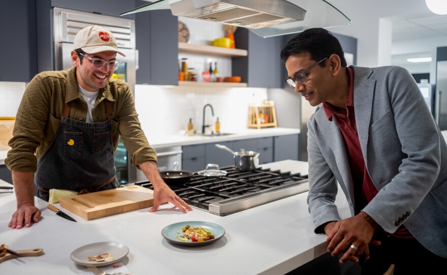 Upside Foods CEO Uma Valeti prepares to sample a recently cooked chicken breast.