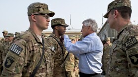 U.S. Defense Secretary Chuck Hagel presents a purple heart to a soldier in Jalalabad, Afghanistan, March 9, 2013.