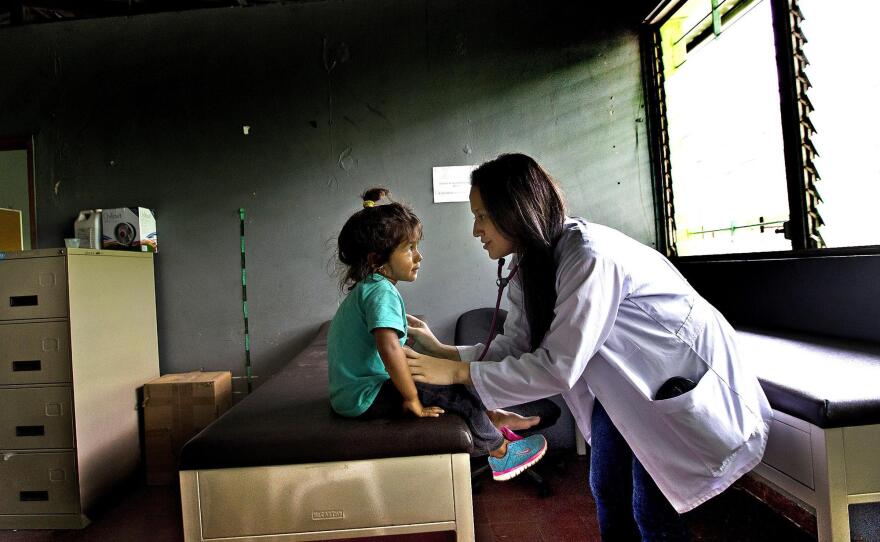 Dr. Mirna Hernández examines 3-year-old Maylin Maybel López at the El Edén center in San Pedro Sula, Honduras. Maylin and her family arrived at the center along with other migrants who were bused back to Honduras after being intercepted in Mexico on an attempt to reach the U.S.