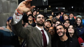 Streamer Hasan Piker, left, and Abdul El-Sayed, a progressive candidate in the Democratic primary for U.S. Senate in Michigan, center right, take a selfie with young fans following a campaign event on April 7, 2026, at the University of Michigan in Ann Arbor.