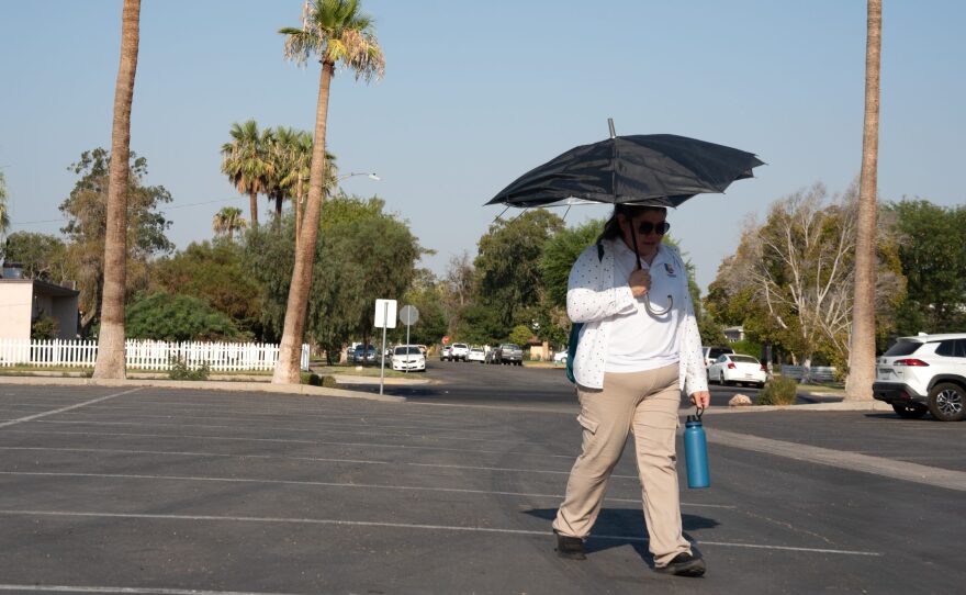 A woman walks to the bus station during the prime heat of an extreme heat day in El Centro on July 15, 2024. She commutes over an hour each way from Calexico.