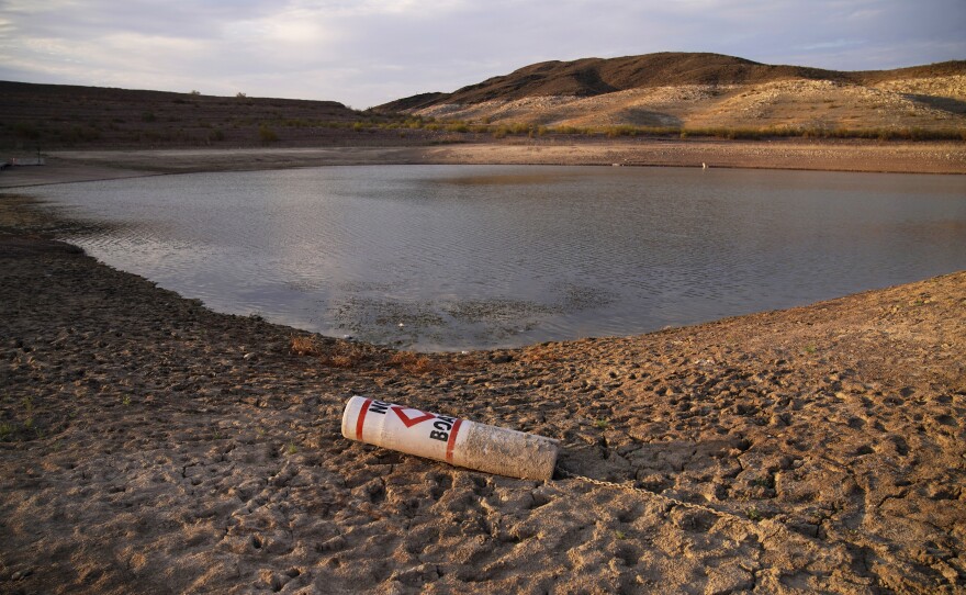 File photo of a buoy rests on the ground at a closed boat ramp on Lake Mead at the Lake Mead National Recreation Area near Boulder City, Nev., on Aug. 13, 2021.