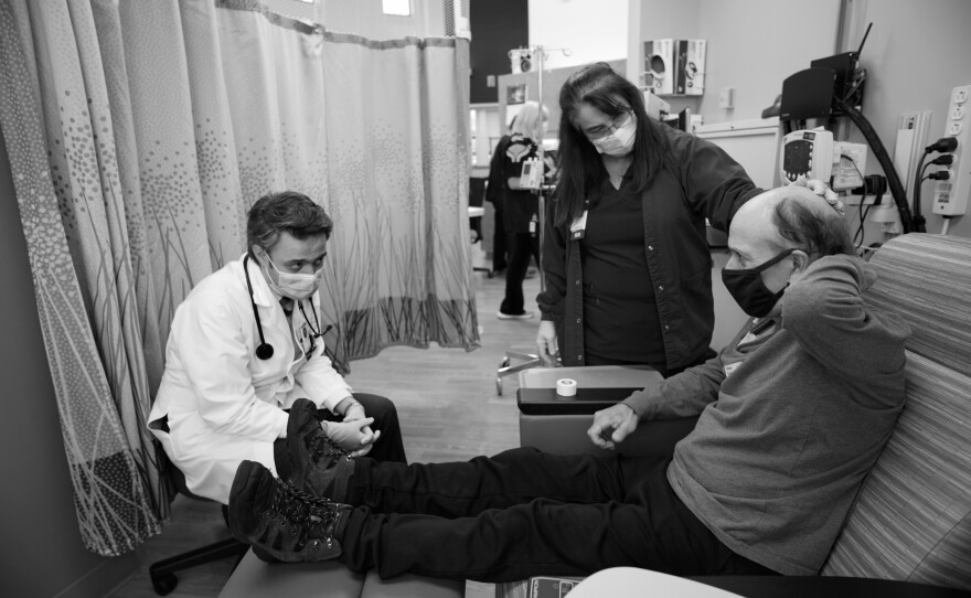 Oncology nurse Lisa Toomey and Dr. Amir Mehrvarz try to determine the cause of the serious pain that patient Alcide Levac is experiencing on Nov. 6, 2020. Many cancer patients delayed their treatments in fear of COVID, exacerbating disease markers and symptoms.