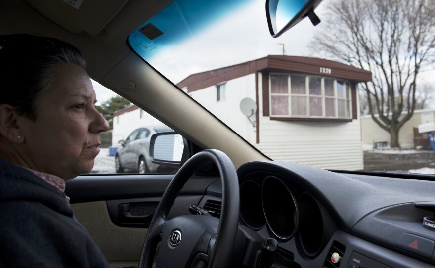 Natividad Seefeld drives through the community. Growing up, her parents kept moving the family from rental to rental. This motivated her to push for the community to become a cooperative since she does not want to move again.