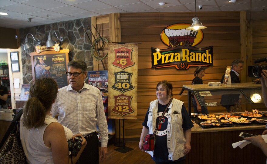 Former Texas Gov. Rick Perry greets Iowans at Fort Dodge Pizza Ranch in July.
