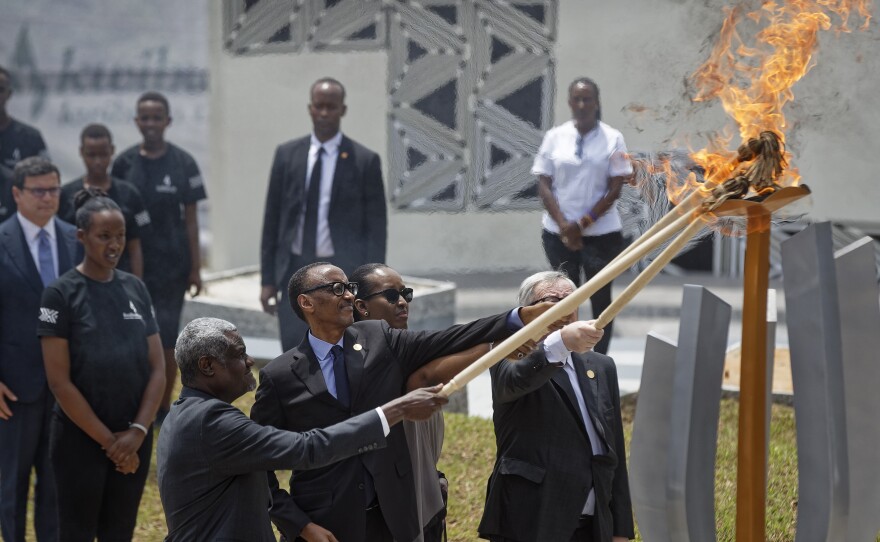 African Union Commission Chairperson Moussa Faki Mahamat (from left), Rwandan President Paul Kagame, Rwandan first lady Jeannette Kagame and European Commission President Jean-Claude Juncker light the flame of remembrance at the Kigali Genocide Memorial in Kigali, Rwanda, on Sunday.
