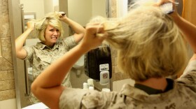 Camp Pendleton Marine does her hair in the morning, 2010.