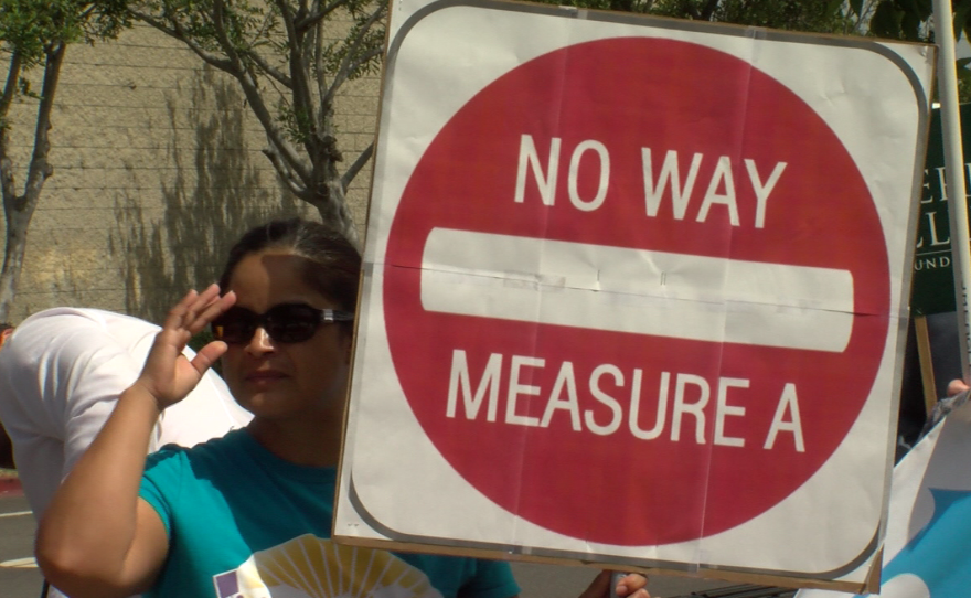 A protester holds a sign reading "No Way Measure A" at a demonstration against the SANDAG tax proposal in National City, Sept. 22, 2016.