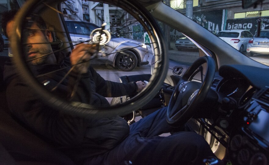 Triantafyllou disassembles his wheelchair to fit it on the back seat of his car.