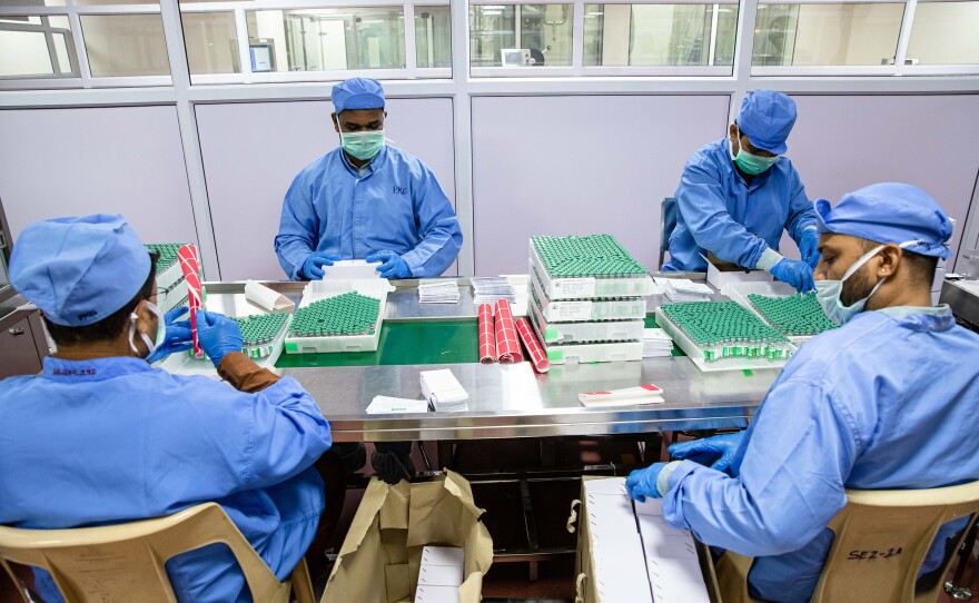 Workers at the Serum Intitute of India pack vials of vaccines into boxes, which are distributed around the world.