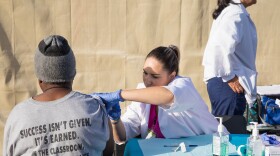 A person receives a vaccine at a homeless campground, Oct. 9, 2017. 