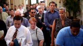Current and former military personnel stand in line while checking in at the Opportunity Job Fair on September 6, 2012 at the old Naval Training Center in San Diego, California.