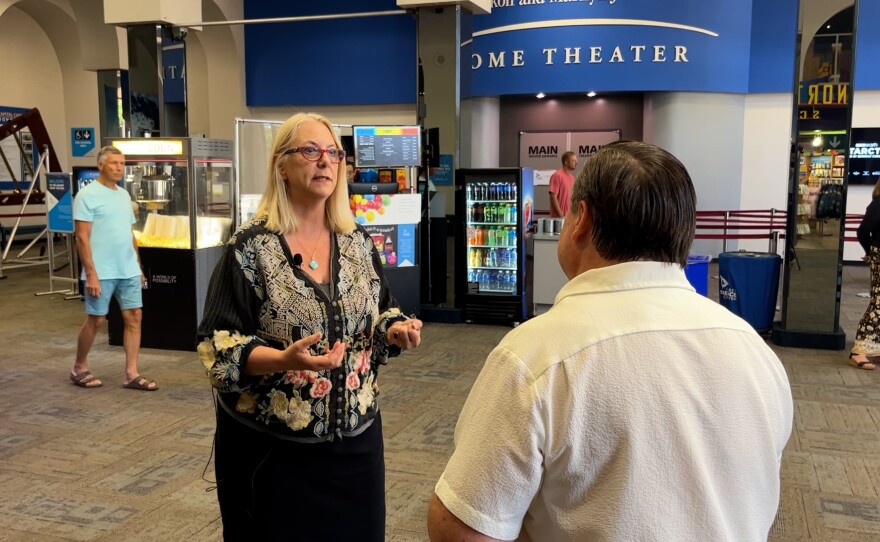 Vice President for Advancement at the Fleet Science Center Chris Lazich is shown speaking with KPBS reporter John Carroll at the Fleet on August 23, 2023.