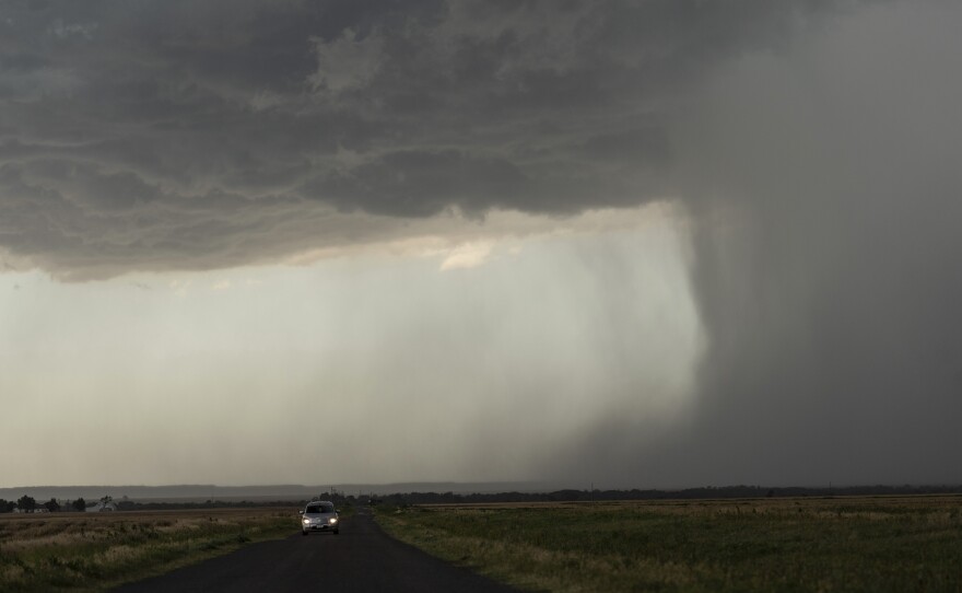 A car moves away from an approaching storm during a Project ICECHIP operation near Tipton, Okla. Project ICECHIP was the first U.S. hail-focused field campaign in more than 40 years. With funding from the National Science Foundation, researchers deployed a network of equipment in 2025 to capture data to improve hail detection, forecasting and warning systems.