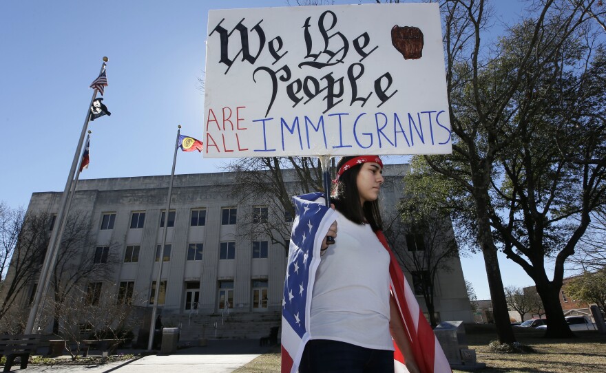 Observing a Day Without Immigrants, high school senior Vicky Sosa holds a sign outside the Grayson County courthouse in Sherman, Texas, Thursday.