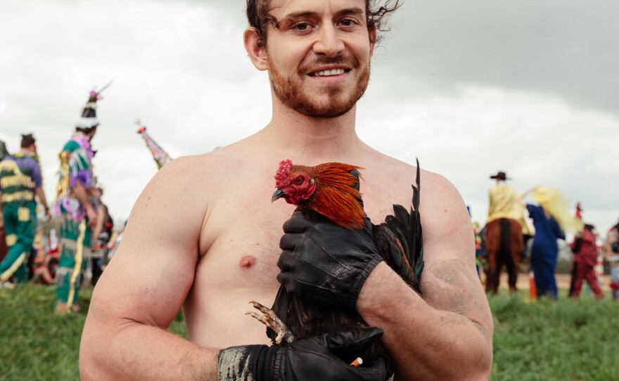 The Mardi Gras who successfully ascended the greased pole and got the chicken.