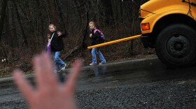 Kristy Stumpf, who works from her home in Broad Run, Va., part of the week, greets her daughters Lauren, 9 (left), and Lacey, 6 (right), as they hop off the school bus. Stumpf's employer, List Innovative Solutions, lets employees largely set their own hours