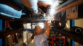 Kevin Doyle from Mad Hatter Muffler shop works on replacing a catalytic converter on a truck on December 7, 2009 in Davie, Florida. The Environmental Protection Agency announced today that greenhouse gases endanger people's health and need to be regulated. This would involve among other measures the regulating of the tailpipe carbon dioxide emissions of cars, which are a large contributor to greenhouse gases.