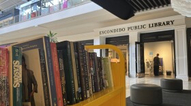 A cart of books stands on the mall floor, outside of the Escondido Public Library, Aug. 26, 2025.